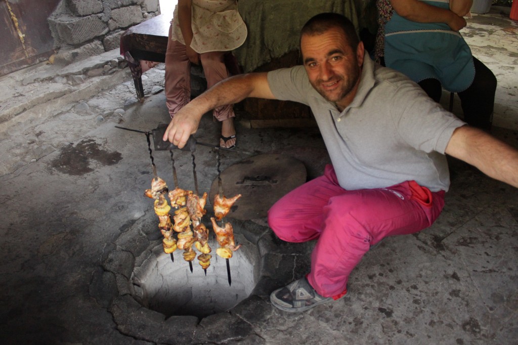 Armen cooking for us chicken in the stone oven