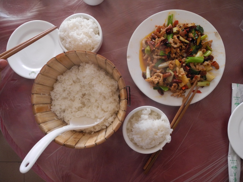 The big bowl of steamed rice is usually free in Chinese restaurants. Here we ate fried pork with vegetables in Zhaotong, Northern Yunnan. 