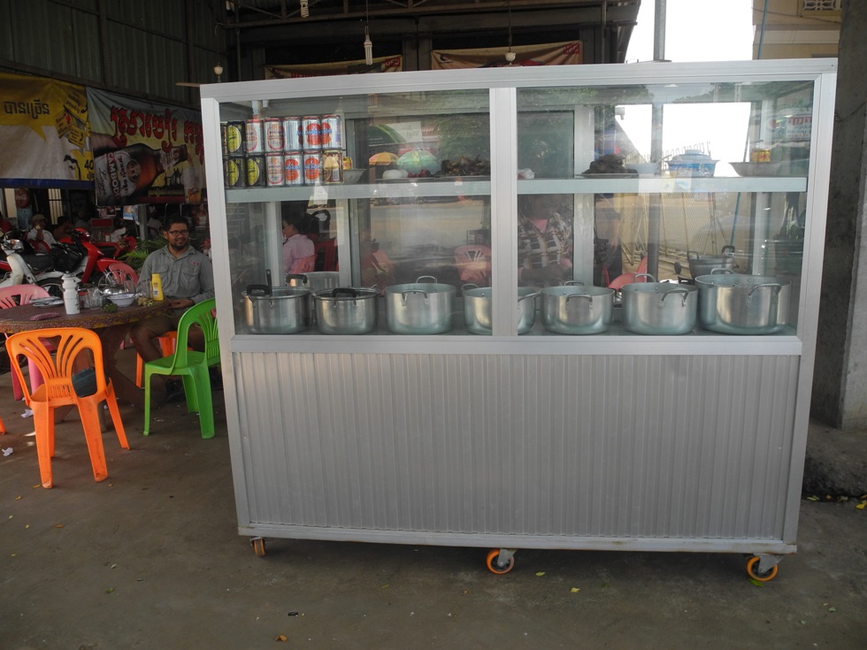 Typical local Cambodian restaurant with pre-cooked food in pots