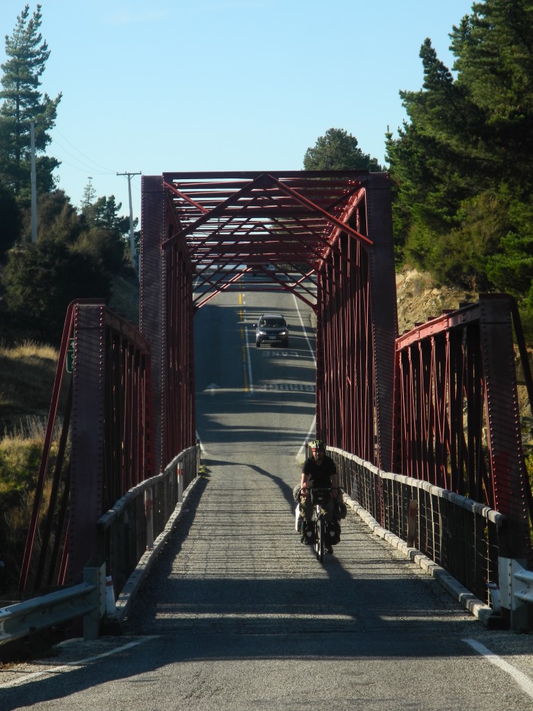 Roberto cycling over a bridge